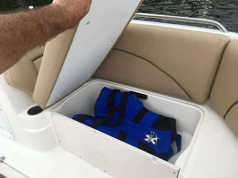 Slide: The Image of Storage compartment on 2023 NauticStar 203SC Sport Deck with life jacket. - 9