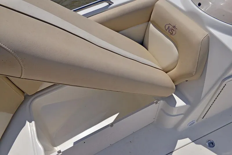 Slide: The Image of 2023 NauticStar 193 Side Console boat interior with beige seating. - 15