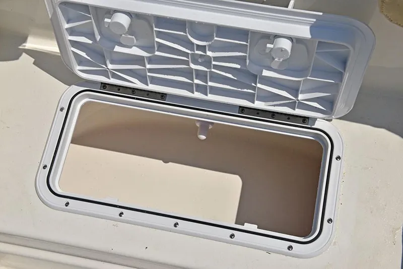 Slide: The Image of Open storage compartment on 2023 NauticStar 193 Side Console boat. - 16