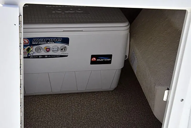 Slide: The Image of Storage compartment with marine cooler in 2023 NauticStar 193 Side Console boat. - 17