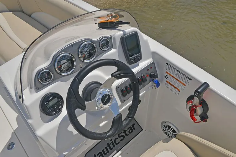 Slide: The Image of 2023 NauticStar 193 Side Console boat dashboard with steering wheel and gauges. - 18
