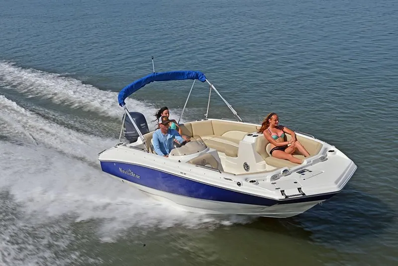 Slide: The Image of 2023 NauticStar 193 Side Console boat cruising with passengers on a sunny day. - 2