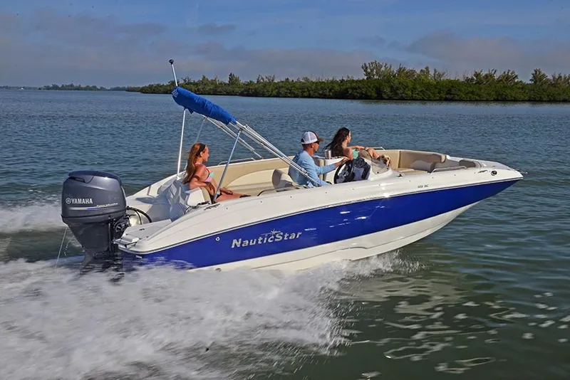 Slide: The Image of 2023 NauticStar 193 Side Console boat cruising on a lake with passengers. - 3