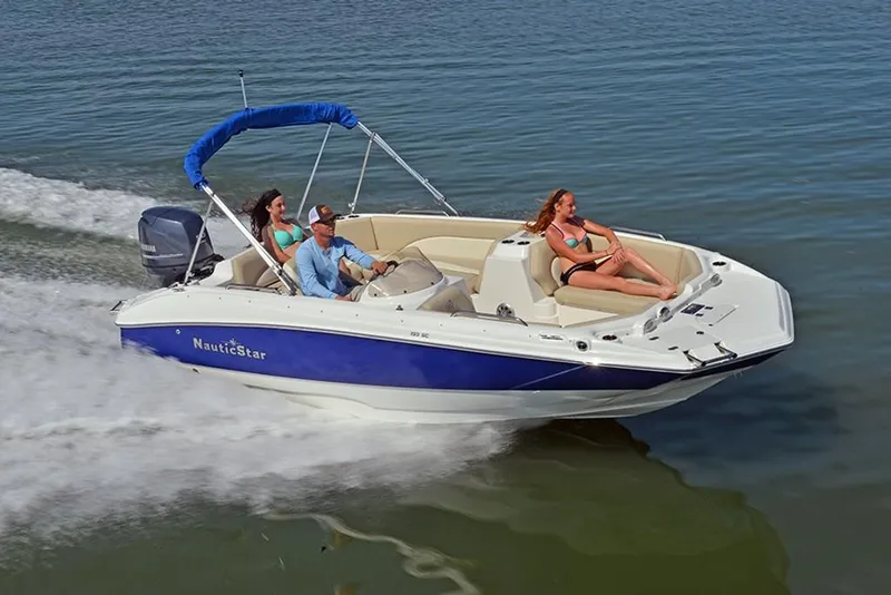 Slide: The Image of 2023 NauticStar 193 Side Console boat cruising on water with passengers. - 4