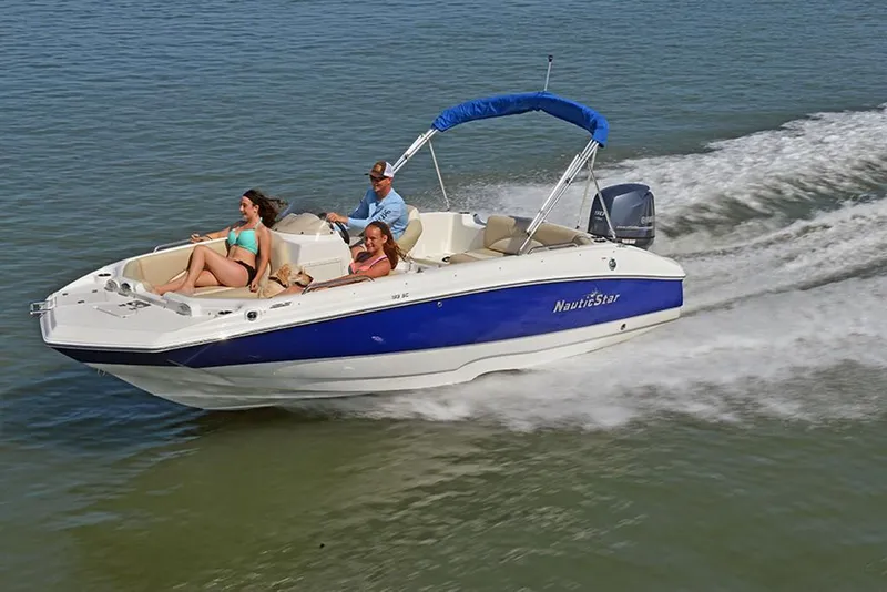 Slide: The Image of 2023 NauticStar 193 Side Console boat cruising with passengers on a sunny day. - 5