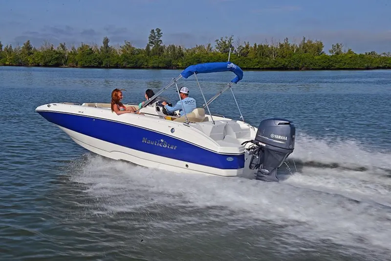 Slide: The Image of 2023 NauticStar 193 Side Console boat cruising on water with passengers. - 6