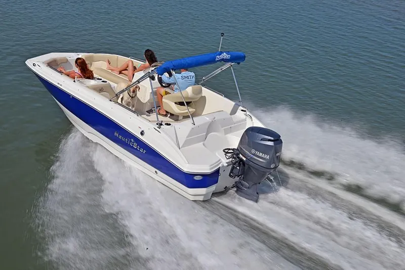 Slide: The Image of 2023 NauticStar 193 Side Console boat cruising on water with Yamaha outboard motor. - 7