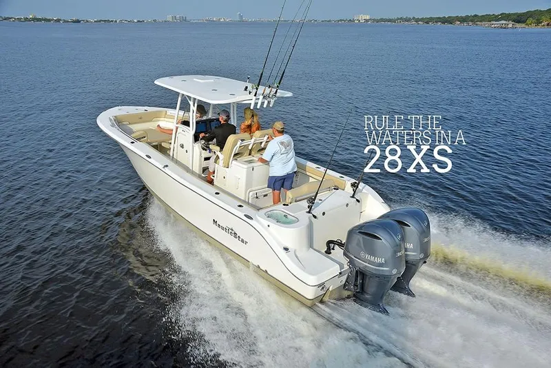 Slide: The Image of 2023 NauticStar 28 XS Offshore boat cruising on open water. - 0