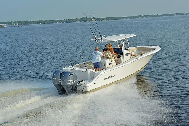 Slide: The Image of 2023 NauticStar 28 XS Offshore boat cruising on open water. - 1