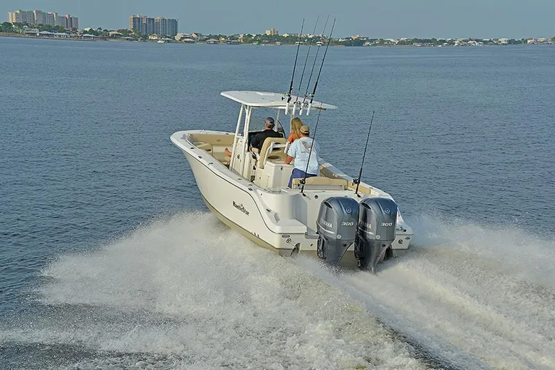 Slide: The Image of 2023 NauticStar 28 XS Offshore boat cruising on open water. - 11