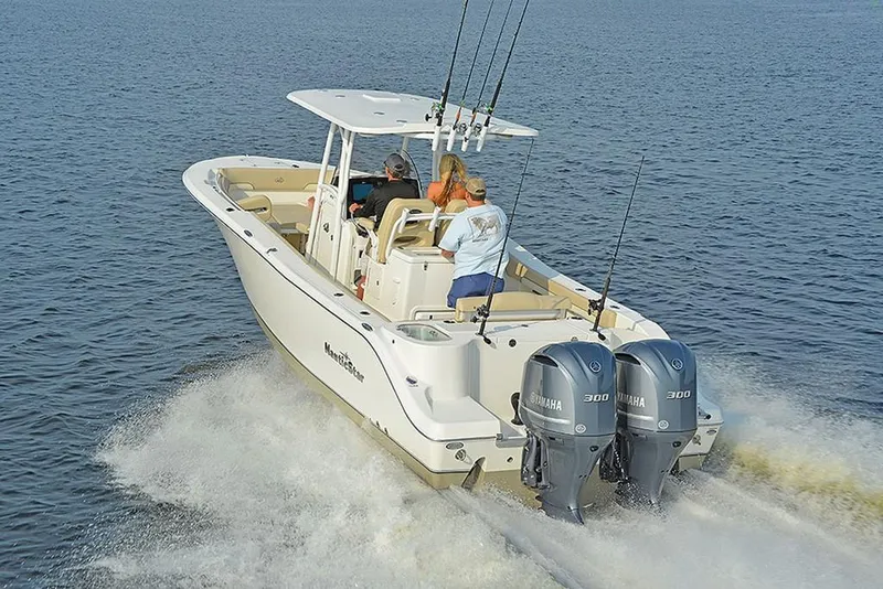 Slide: The Image of 2023 NauticStar 28 XS Offshore boat cruising on water with dual Yamaha engines. - 12