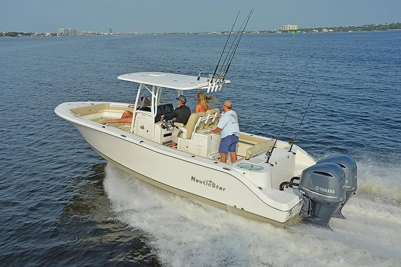 Slide: The Image of 2023 NauticStar 28 XS Offshore boat cruising on open water. - 2
