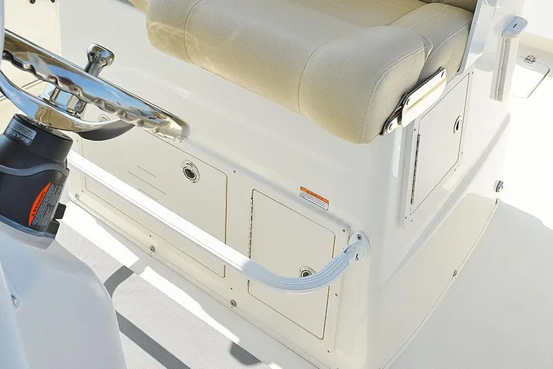 Slide: The Image of 2023 NauticStar 28 XS Offshore boat interior with beige seating and storage compartments. - 21