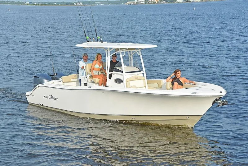 Slide: The Image of 2023 NauticStar 28 XS Offshore boat cruising with passengers on a calm sea. - 4