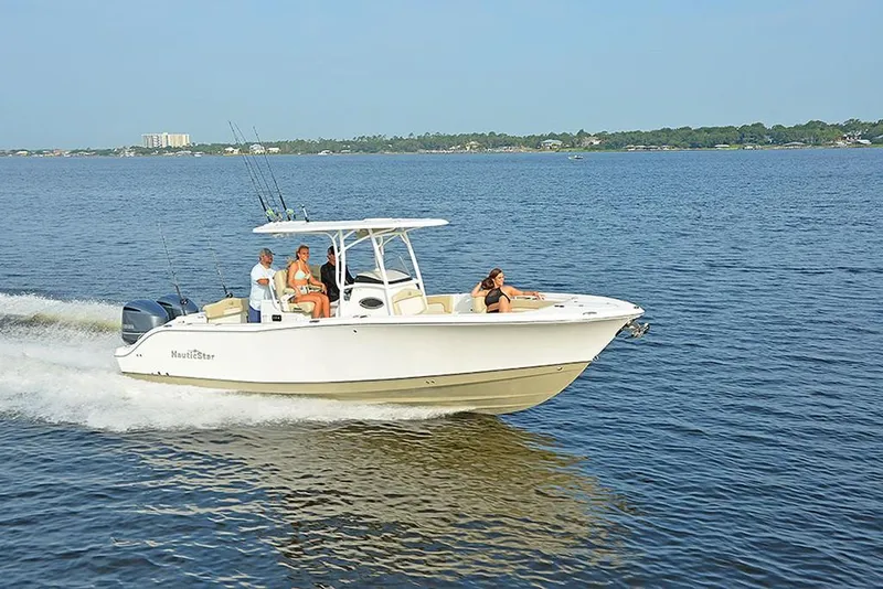 Slide: The Image of 2023 NauticStar 28 XS Offshore boat cruising on open water. - 5