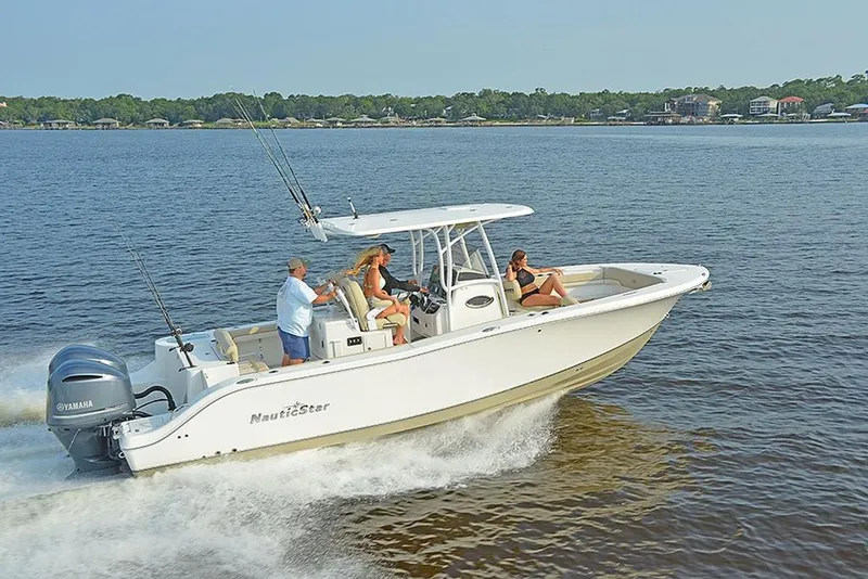 Slide: The Image of 2023 NauticStar 28 XS Offshore boat cruising on the water with passengers. - 6