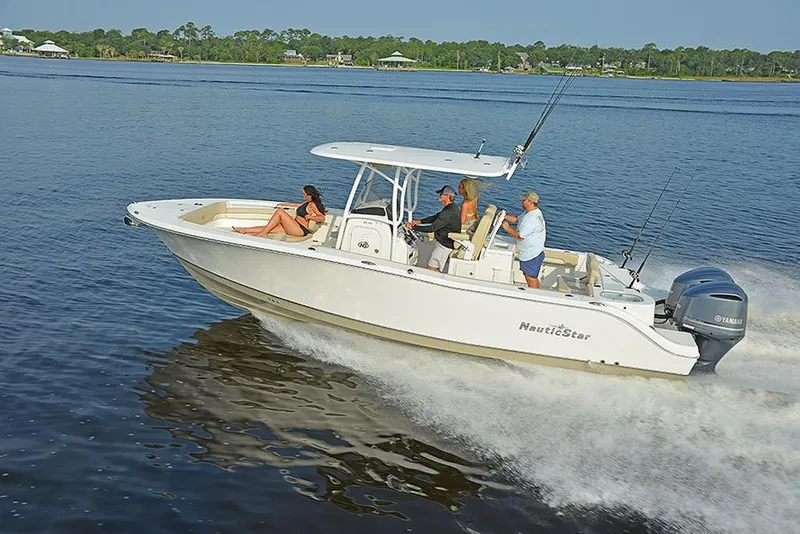 Slide: The Image of 2023 NauticStar 28 XS Offshore boat cruising on a lake with passengers. - 7