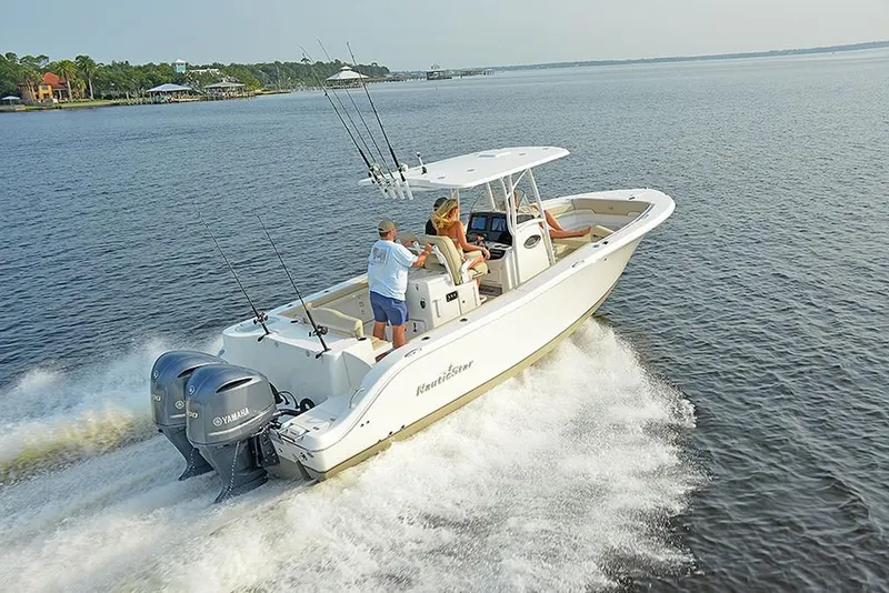 Slide: The Image of 2023 NauticStar 28 XS Offshore boat cruising on open water. - 8