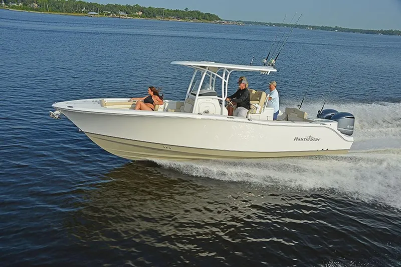 Slide: The Image of 2023 NauticStar 28 XS Offshore boat cruising on open water. - 9