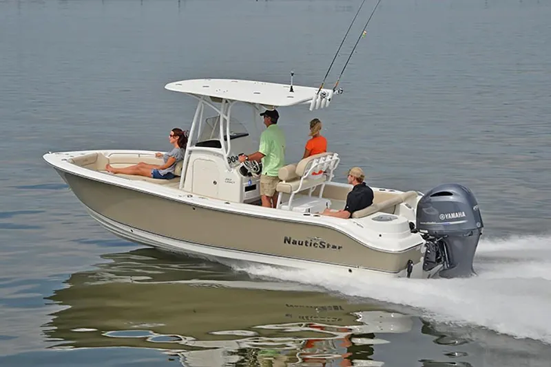 Slide: The Image of 2023 NauticStar 2302 Legacy boat cruising on calm water. - 1