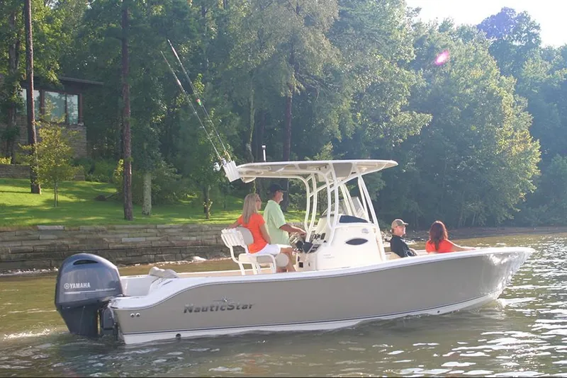 Slide: The Image of 2023 NauticStar 2302 Legacy boat cruising on a lake with passengers. - 10