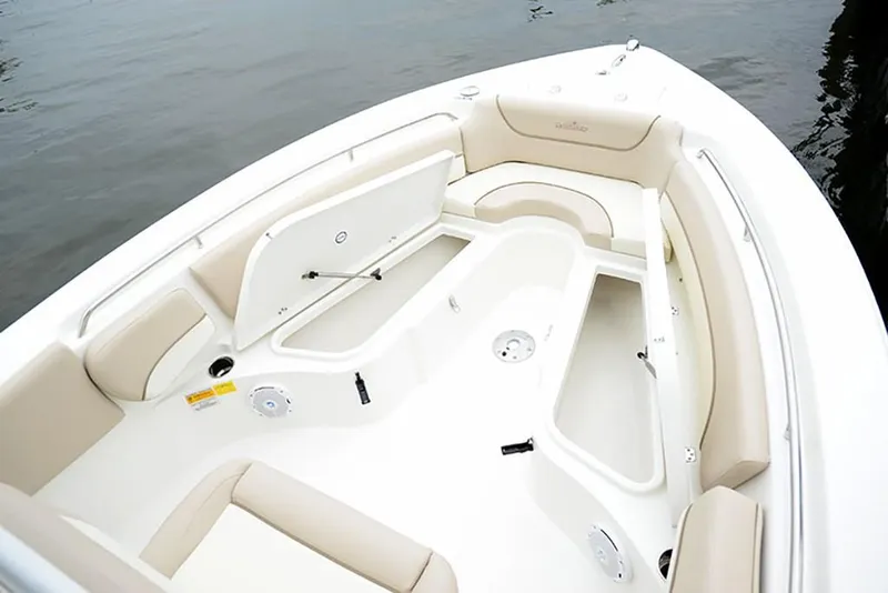 Slide: The Image of 2023 NauticStar 2302 Legacy boat interior with beige seating and storage compartments. - 21