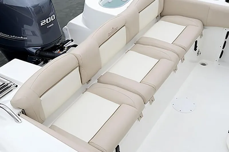 Slide: The Image of 2023 NauticStar 2302 Legacy boat with beige and white cushioned seating. - 24
