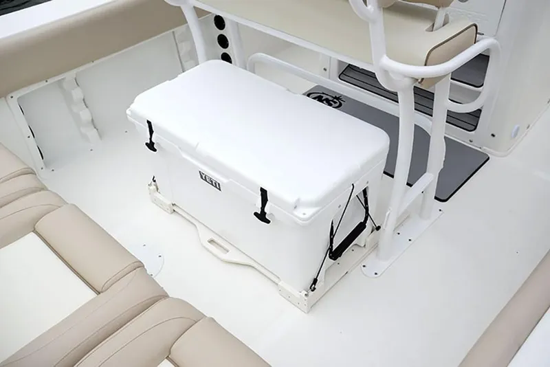 Slide: The Image of 2023 NauticStar 2302 Legacy boat interior with white cooler and beige seating. - 31