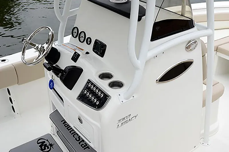 Slide: The Image of 2023 NauticStar 2302 Legacy boat console with steering wheel and control panel. - 32