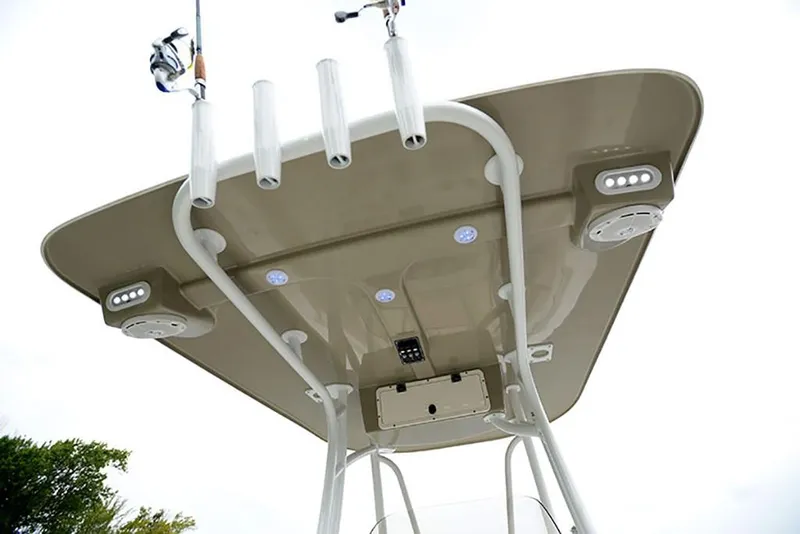 Slide: The Image of 2023 NauticStar 2302 Legacy boat T-top with rod holders and LED lights. - 36