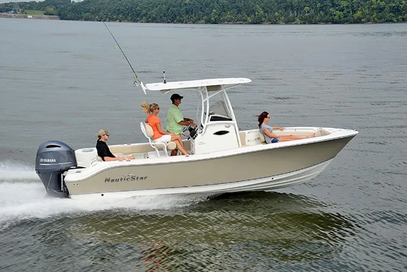 Slide: The Image of 2023 NauticStar 2302 Legacy boat cruising on a lake with passengers. - 6