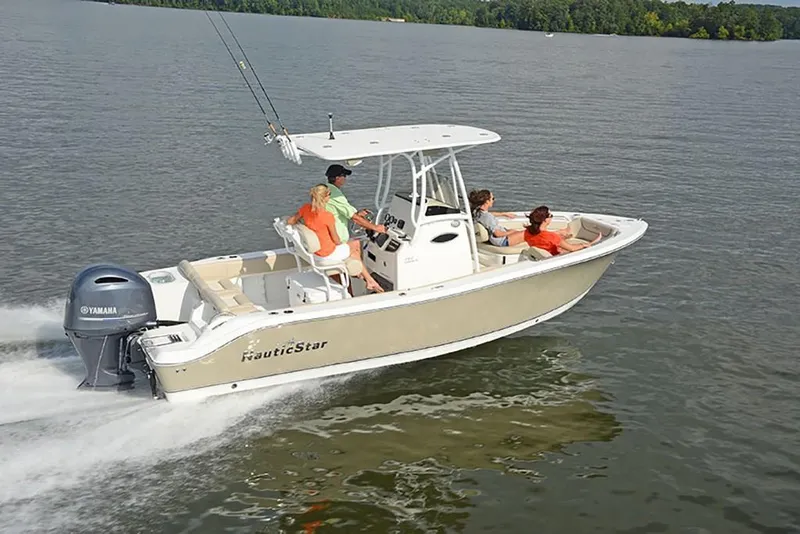 Slide: The Image of 2023 NauticStar 2302 Legacy boat cruising on a lake with passengers. - 7