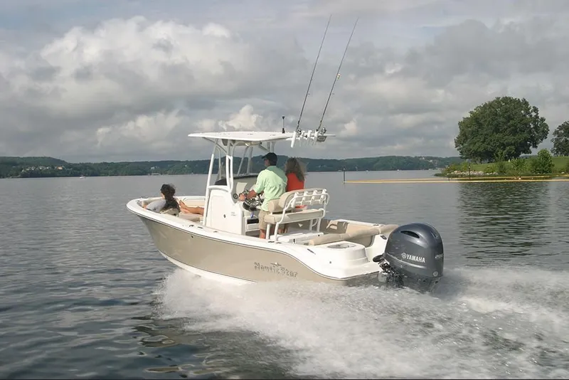 Slide: The Image of 2023 NauticStar 2302 Legacy boat cruising on a lake with passengers. - 8