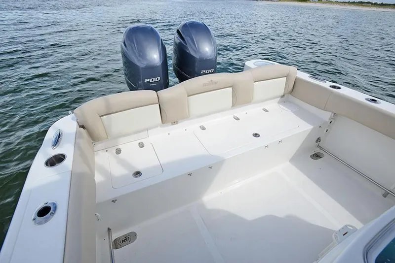 Slide: The Image of 2023 NauticStar 2602 Legacy boat with twin 200 horsepower engines on water. - 13