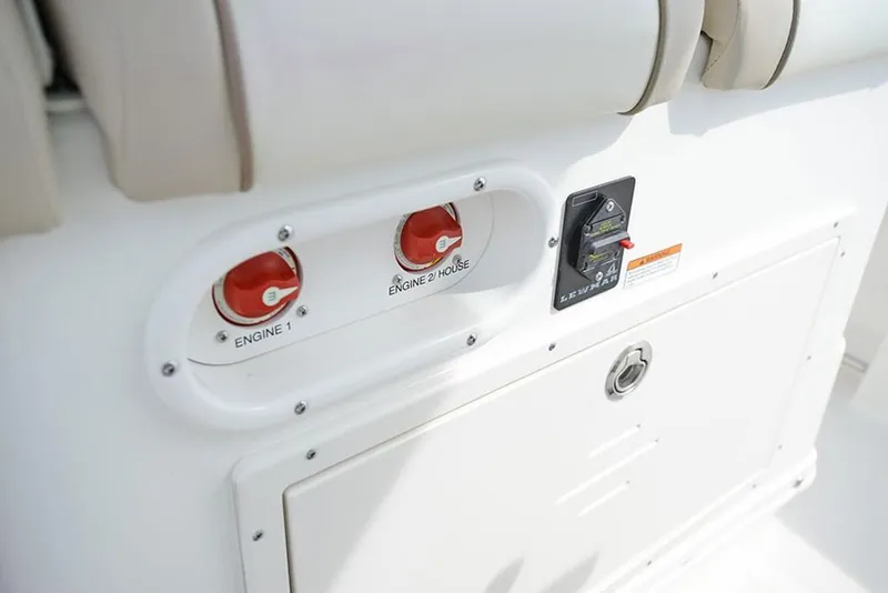 Slide: The Image of 2023 NauticStar 2602 Legacy boat engine controls and switches. - 16