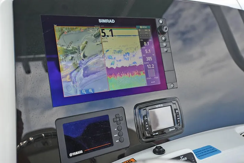 Slide: The Image of 2023 NauticStar 2602 Legacy boat dashboard with Simrad navigation system. - 17