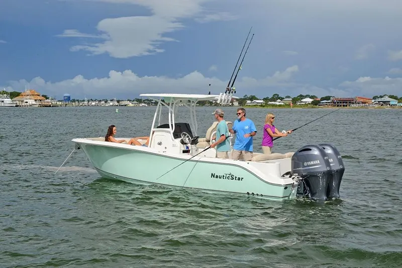 Slide: The Image of 2023 NauticStar 2602 Legacy boat with people fishing and relaxing on the water. - 2
