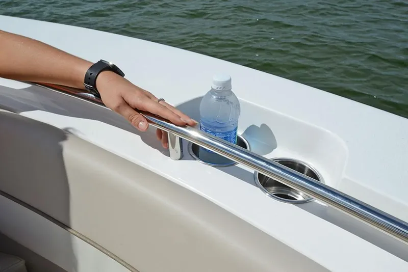Slide: The Image of Hand on rail of 2023 NauticStar 2602 Legacy boat with cup holders. - 20