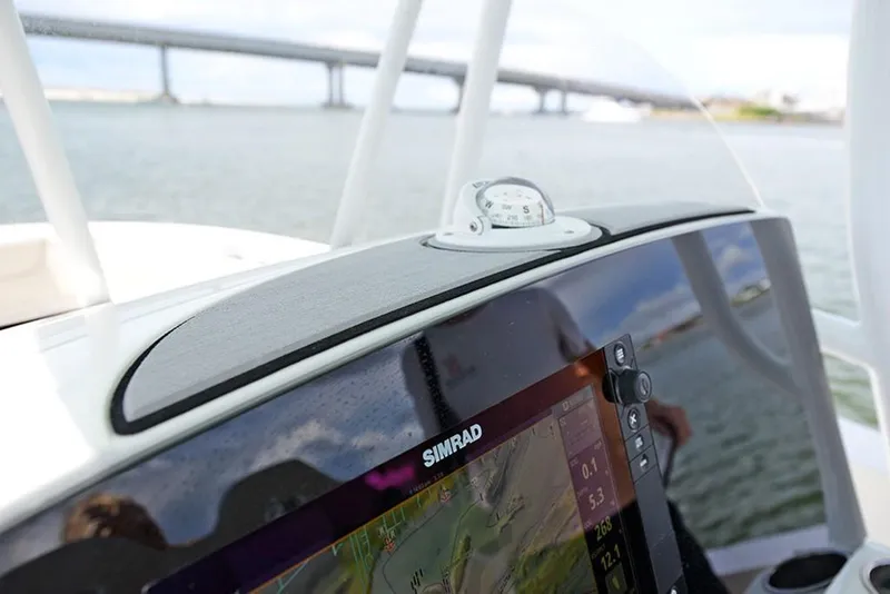 Slide: The Image of 2023 NauticStar 2602 Legacy boat dashboard with Simrad navigation system. - 29