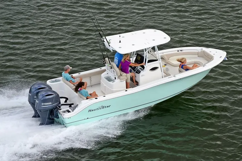 Slide: The Image of 2023 NauticStar 2602 Legacy boat cruising with passengers on open water. - 4
