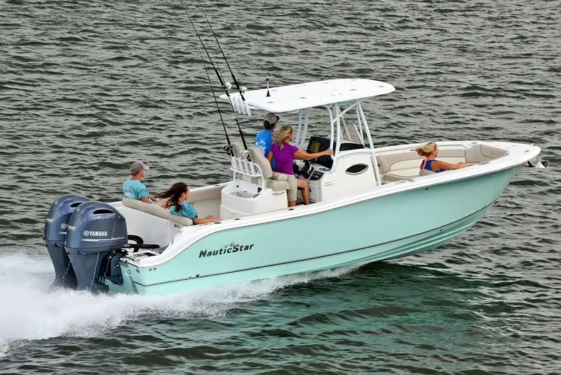 Slide: The Image of 2023 NauticStar 2602 Legacy boat cruising on water with passengers. - 6