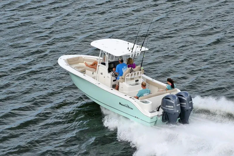 Slide: The Image of 2023 NauticStar 2602 Legacy boat cruising on water with passengers. - 7