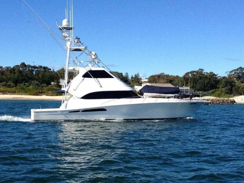 Slide: The Image of 2004 Riviera 58 Enclosed Flybridge yacht cruising on water. - 0