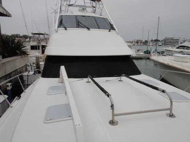 Slide: The Image of 2004 Riviera 58 Enclosed Flybridge yacht docked at marina. - 12