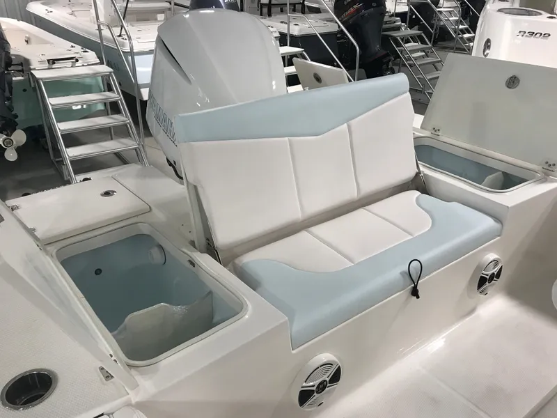 Slide: The Image of 2024 Robalo 246 Cayman Sky Deck boat interior with seating and storage compartments. - 13