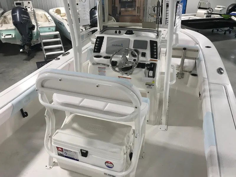 Slide: The Image of 2024 Robalo 246 Cayman Sky Deck boat interior with helm and seating. - 5