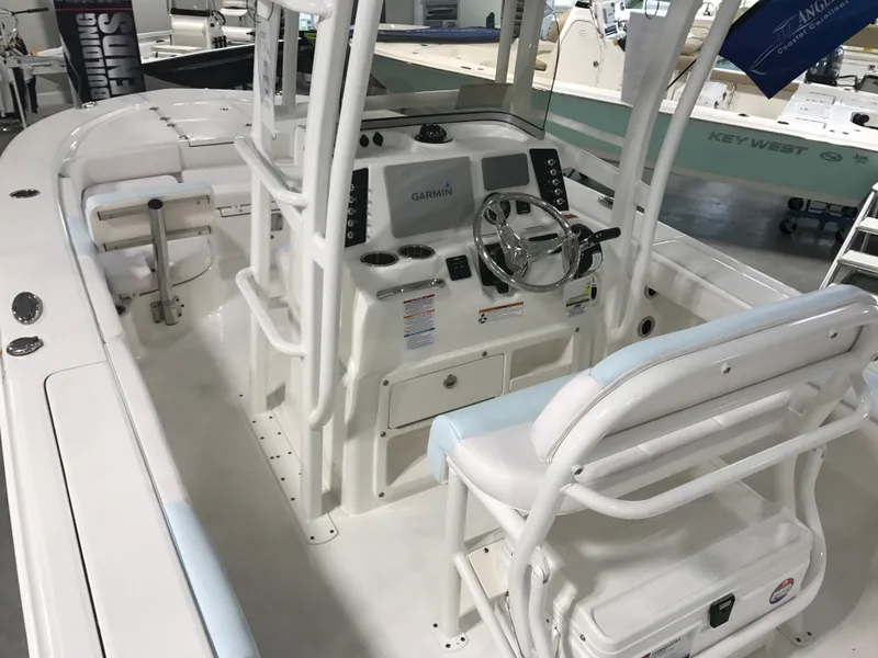 Slide: The Image of 2024 Robalo 246 Cayman Sky Deck boat interior with helm station and seating. - 7