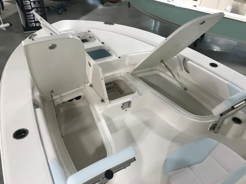 Slide: The Image of 2024 Robalo 246 Cayman Sky Deck boat interior with open storage compartments. - 9