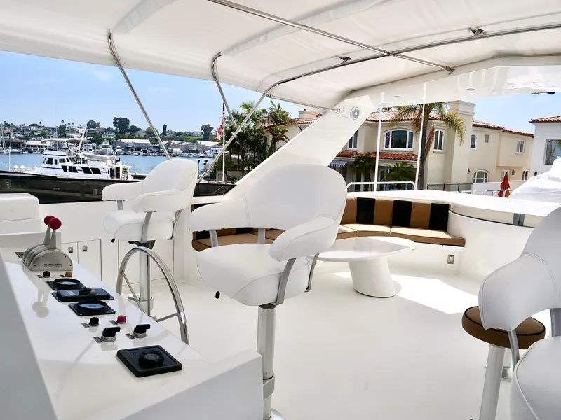 Slide: The Image of Luxurious 2000 Westport 112 yacht's upper deck with helm station and seating area. - 10