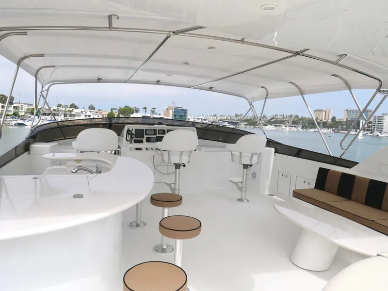 Slide: The Image of Luxurious 2000 Westport 112 yacht with spacious outdoor seating and bar area. - 11